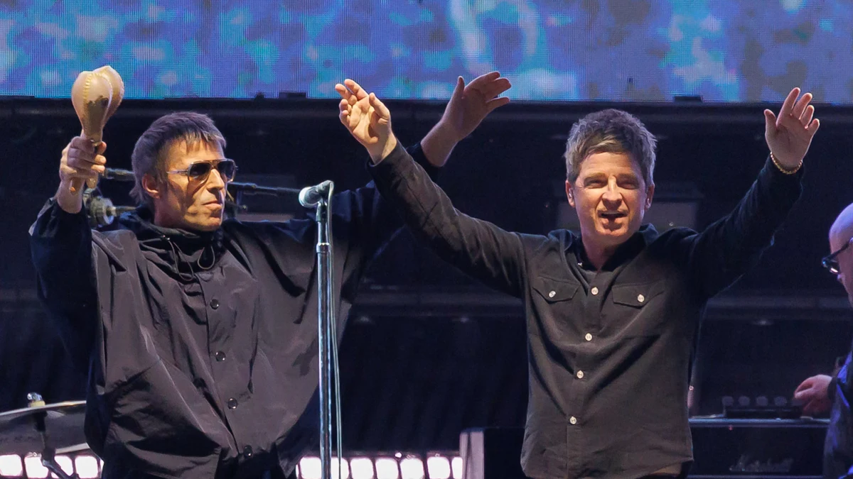 Liam and Noel Gallagher performing together live on stage for Oasis Live '27 reunion tour